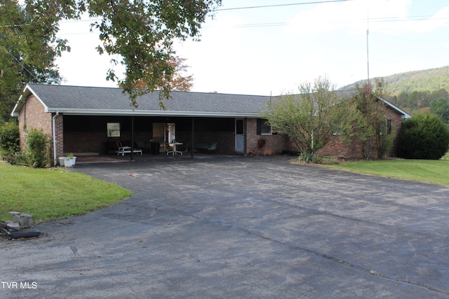 single story home featuring a front yard and a carport