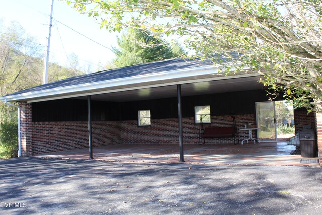 view of vehicle parking with a carport