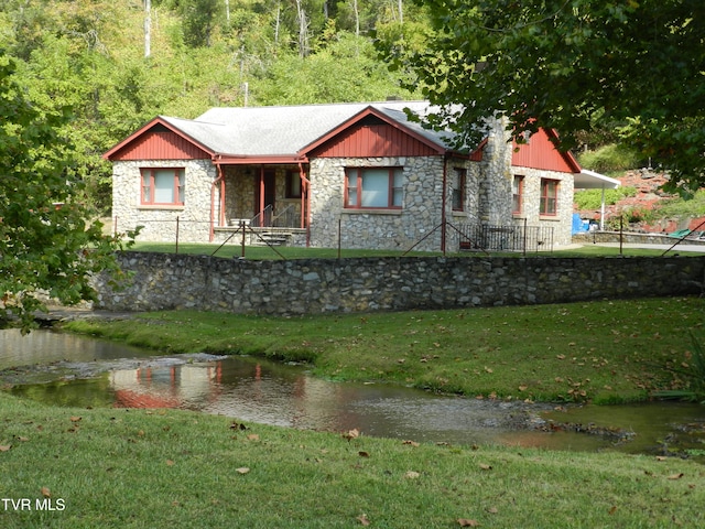 view of front of home with a water view and a front yard