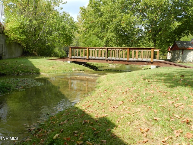 view of yard featuring a deck with water view