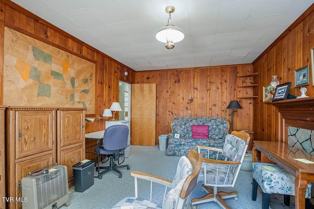 carpeted office space featuring crown molding and wooden walls