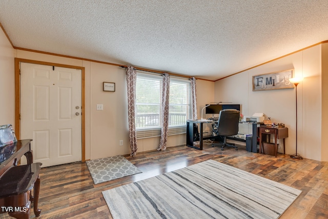 office space featuring a textured ceiling, ornamental molding, and dark hardwood / wood-style floors