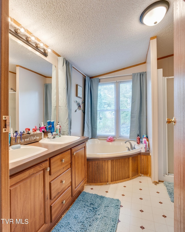 bathroom with a textured ceiling, ornamental molding, vanity, and plus walk in shower