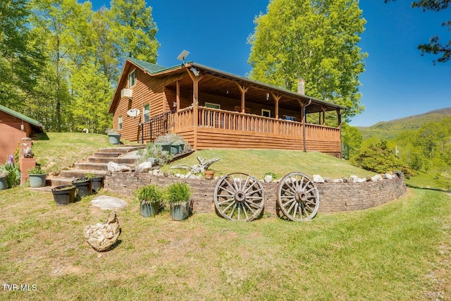 rear view of property with a lawn and a deck