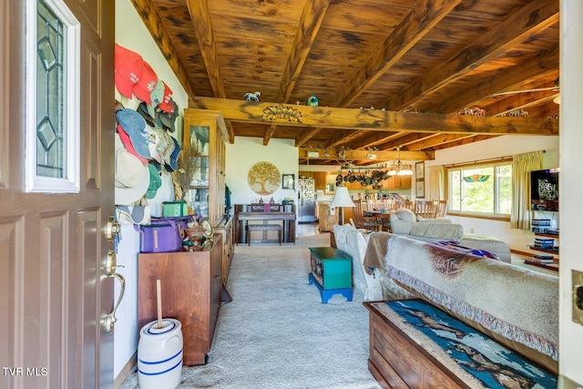 carpeted living room featuring bar, beam ceiling, and wooden ceiling