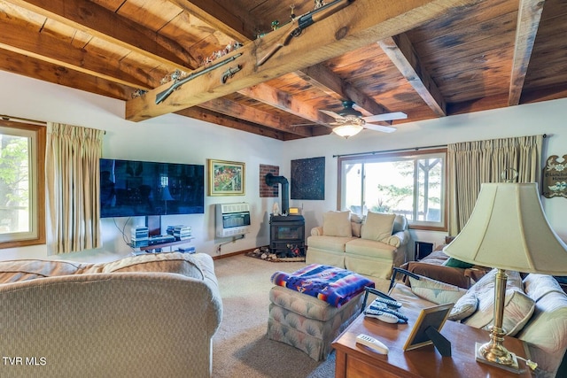 carpeted living room featuring wooden ceiling, ceiling fan, a wood stove, and plenty of natural light