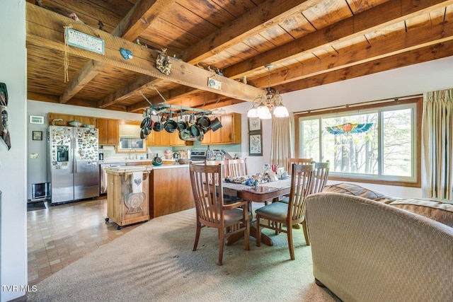 dining area with beamed ceiling, wood ceiling, sink, and a notable chandelier