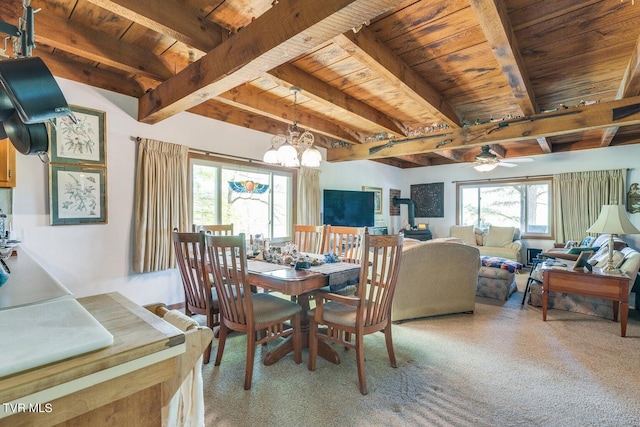 carpeted dining room with ceiling fan with notable chandelier, wood ceiling, and beam ceiling