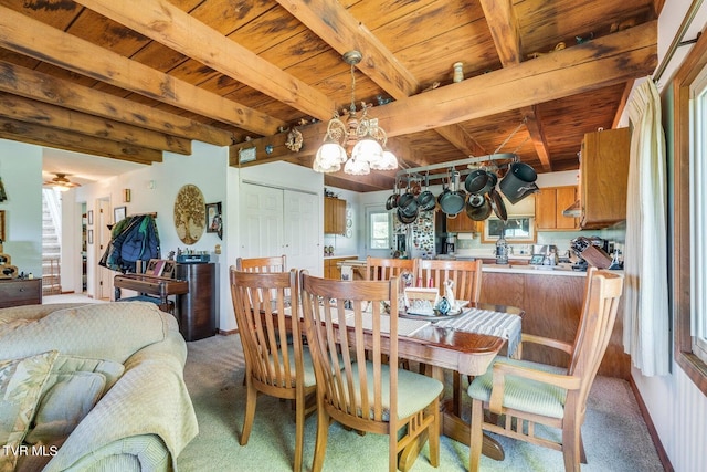 carpeted dining area featuring beam ceiling, a chandelier, and wooden ceiling