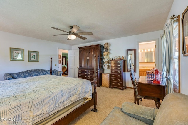 bedroom with connected bathroom, ceiling fan, light colored carpet, and a textured ceiling