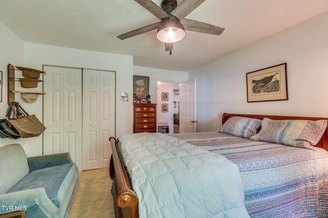 carpeted bedroom with ceiling fan, a textured ceiling, and a closet