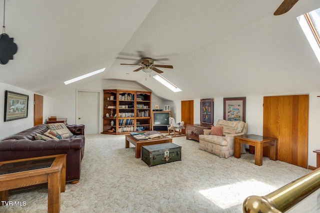 living room featuring vaulted ceiling with skylight, carpet, and ceiling fan