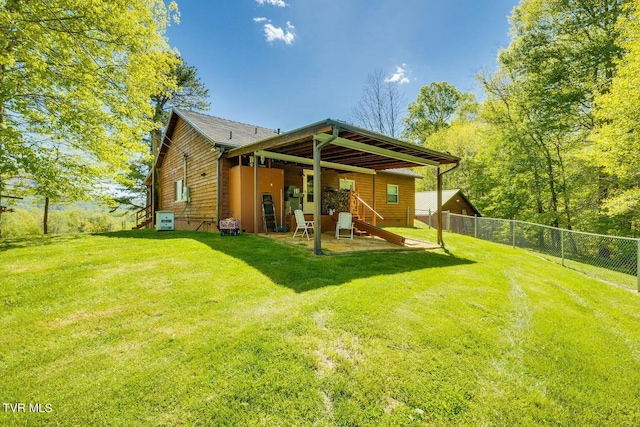 rear view of property with a patio area and a yard