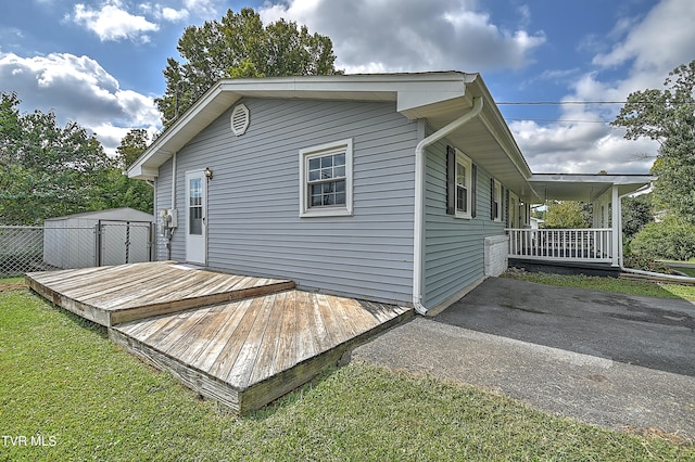 exterior space with covered porch, a yard, and a shed