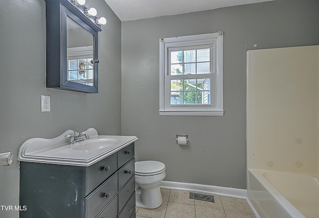 bathroom with a textured ceiling, tile patterned flooring, vanity, and toilet