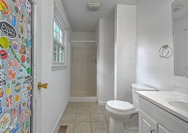 bathroom with tile patterned flooring, a textured ceiling, walk in shower, vanity, and toilet