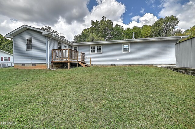 back of house with a wooden deck and a yard