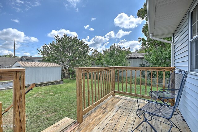 wooden deck featuring a storage shed and a yard