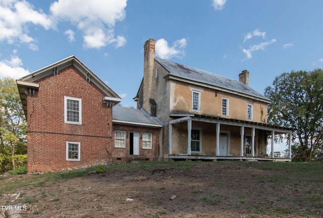 2666 Main St, Surgoinsville, TN 37873 - back of property featuring brick siding, a porch, and a chimney