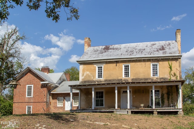 back of property featuring a porch