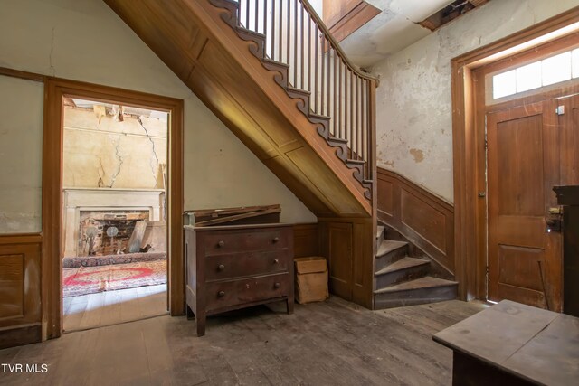 2666 Main St, Surgoinsville, TN 37873 - interior space with lofted ceiling, stairs, a wainscoted wall, a decorative wall, and wood finished floors
