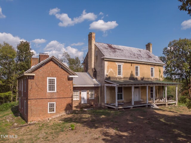 rear view of house featuring a porch