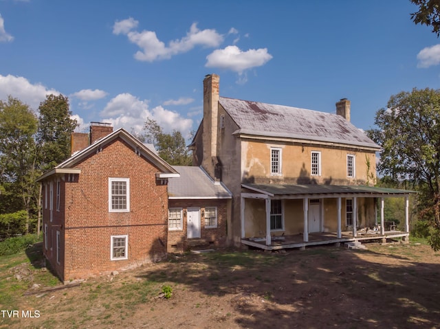 2666 Main St, Surgoinsville, TN 37873 - back of property featuring a chimney, covered porch, and brick siding