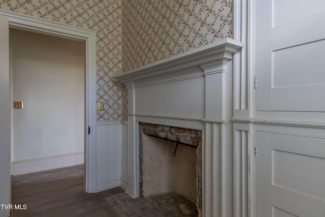 2666 Main St, Surgoinsville, TN 37873 - interior details featuring a wainscoted wall, a fireplace, wallpapered walls, and wood finished floors
