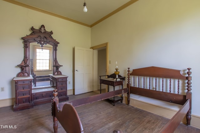 bedroom with crown molding and dark hardwood / wood-style flooring