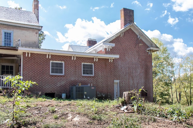 2666 Main St, Surgoinsville, TN 37873 - view of home's exterior with a chimney, central AC, and brick siding
