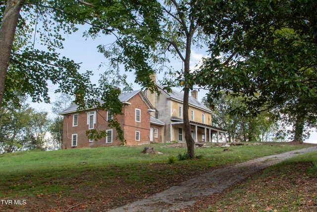 2666 Main St, Surgoinsville, TN 37873 - view of front of home with a chimney and a front lawn