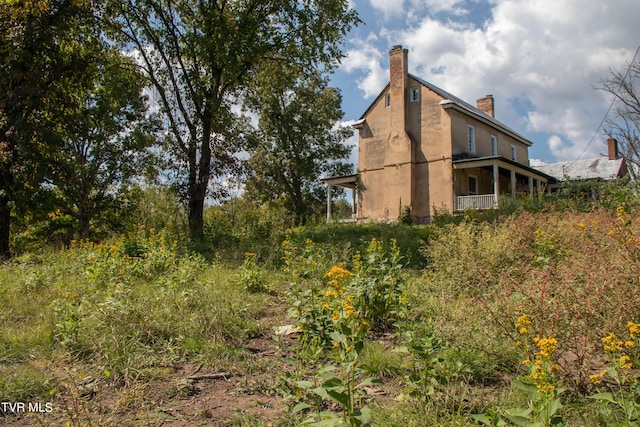 2666 Main St, Surgoinsville, TN 37873 - view of home's exterior featuring stucco siding and a chimney