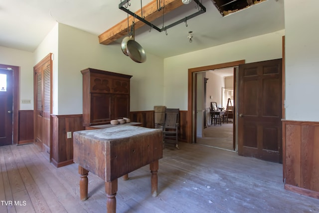 interior space featuring hardwood / wood-style floors and beamed ceiling