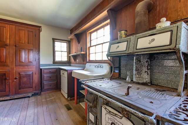 kitchen with decorative backsplash and light hardwood / wood-style floors