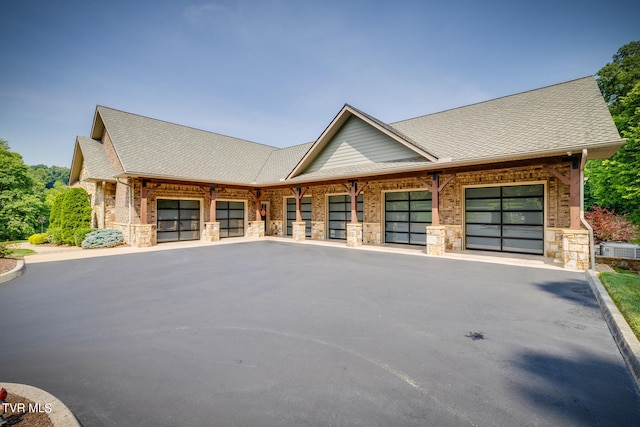 view of front of home with central AC and a garage