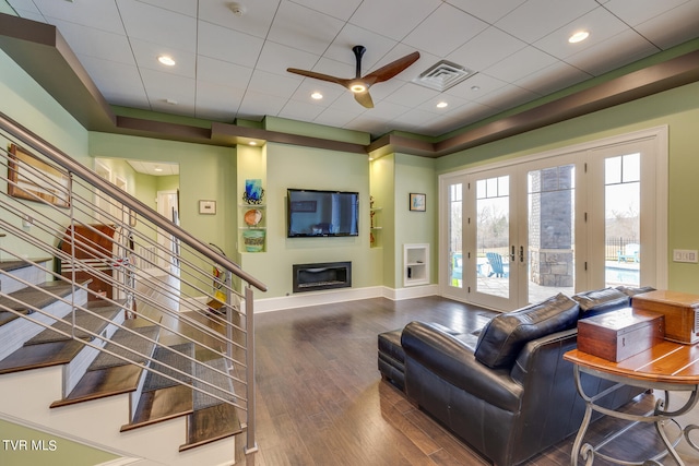 living room with ceiling fan and wood-type flooring