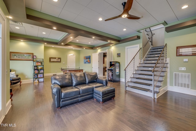 living room with a tray ceiling, ceiling fan, and hardwood / wood-style flooring