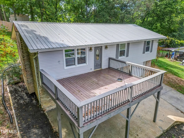 rear view of property with a wooden deck