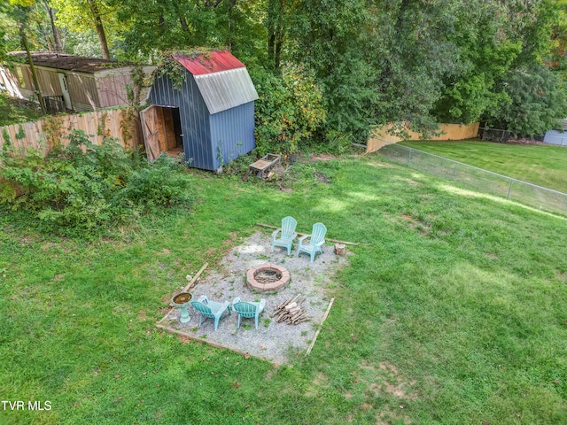 view of yard featuring a storage unit and a fire pit