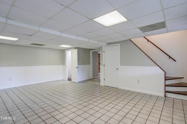 basement with a paneled ceiling