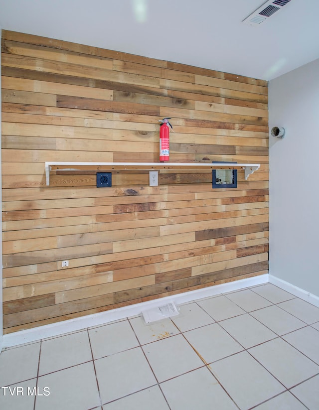 details featuring wood walls and tile patterned floors