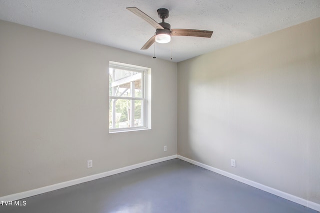 unfurnished room with ceiling fan, a textured ceiling, and concrete floors