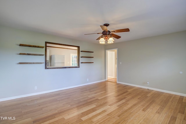 spare room with light hardwood / wood-style floors and ceiling fan