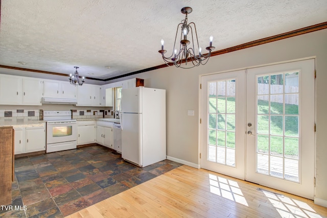 kitchen featuring white cabinets, white appliances, decorative light fixtures, crown molding, and dark hardwood / wood-style flooring