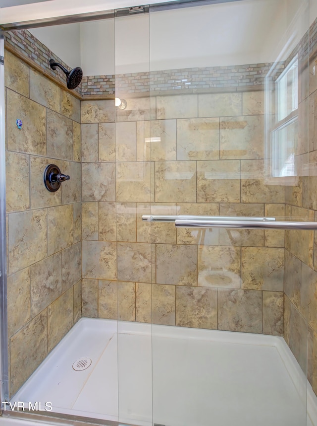 bathroom with tiled shower