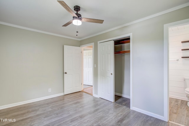 unfurnished bedroom featuring light hardwood / wood-style flooring, a closet, ceiling fan, and ornamental molding