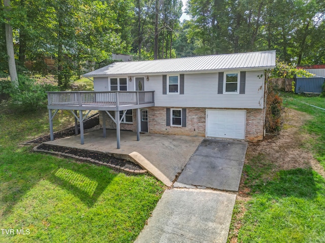 view of front of property with a patio, a front yard, a deck, and a garage