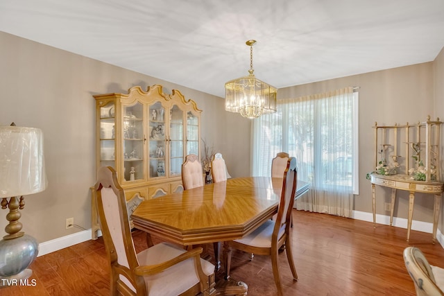 dining area featuring a notable chandelier and hardwood / wood-style floors