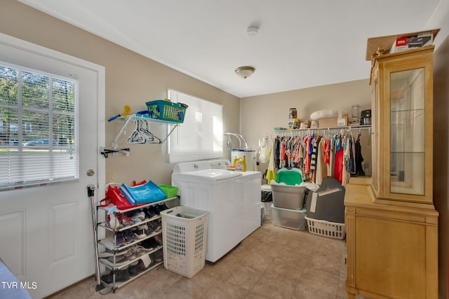 washroom featuring water heater and independent washer and dryer