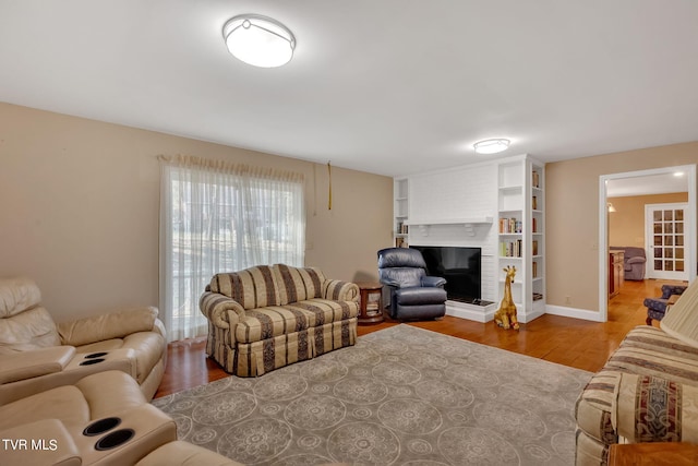 living room with hardwood / wood-style flooring and a fireplace